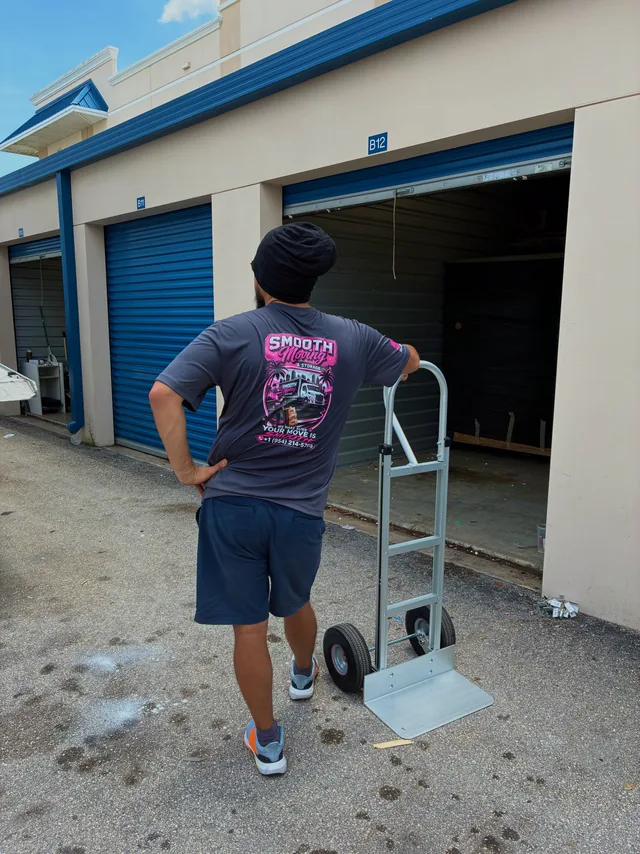Crew member with a hand truck at a storage unit