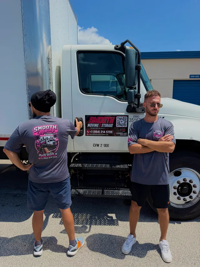 Two crew members beside the company truck