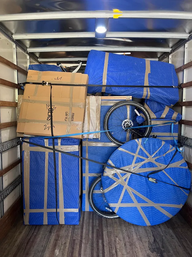 Interior of the truck packed with strapped, blanketed furniture